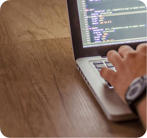 Hands typing on a laptop